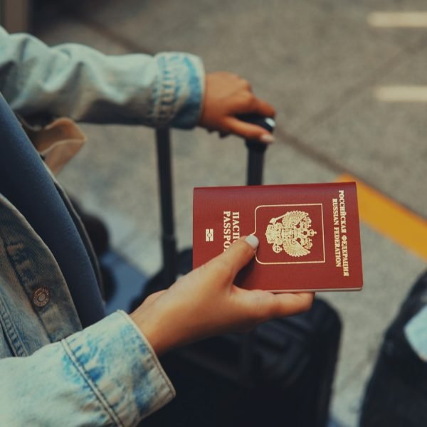 a person holding a red passport in their hand